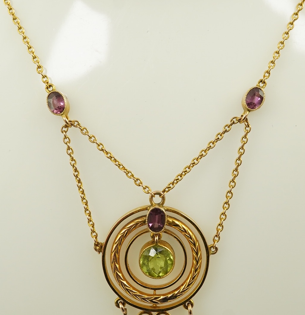 An Edwardian 9ct gold, peridot and garnet set drop pendant necklace, by Murrle Bennett & Co